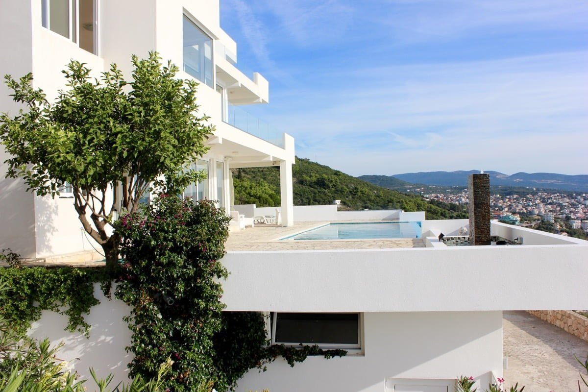 Modern villa with a swimming pool and panoramic sea view in Dobra Voda, Montenegro. White facade and terrace.