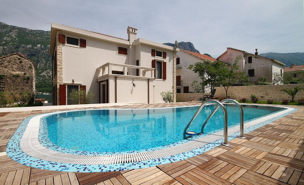 Villa with a pool and wooden terrace in Prčanj, Montenegro: view of a Mediterranean-style house and mountains.