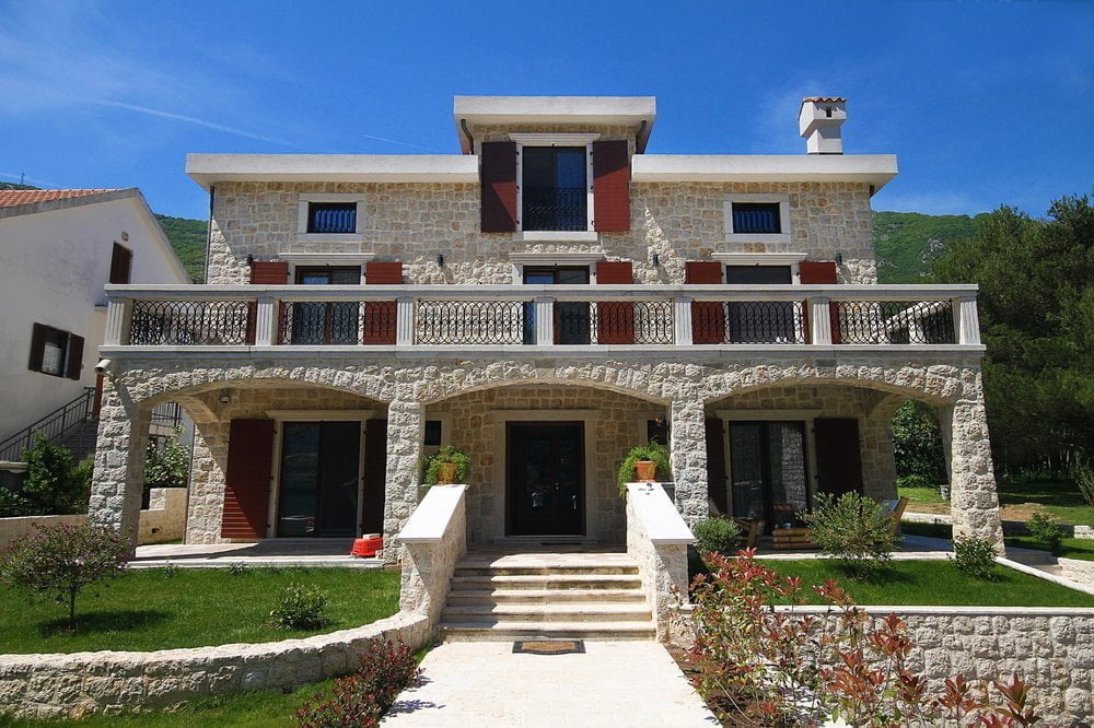 Three-story stone villa in Mediterranean style with a terrace and garden in Prčanj, Montenegro.
