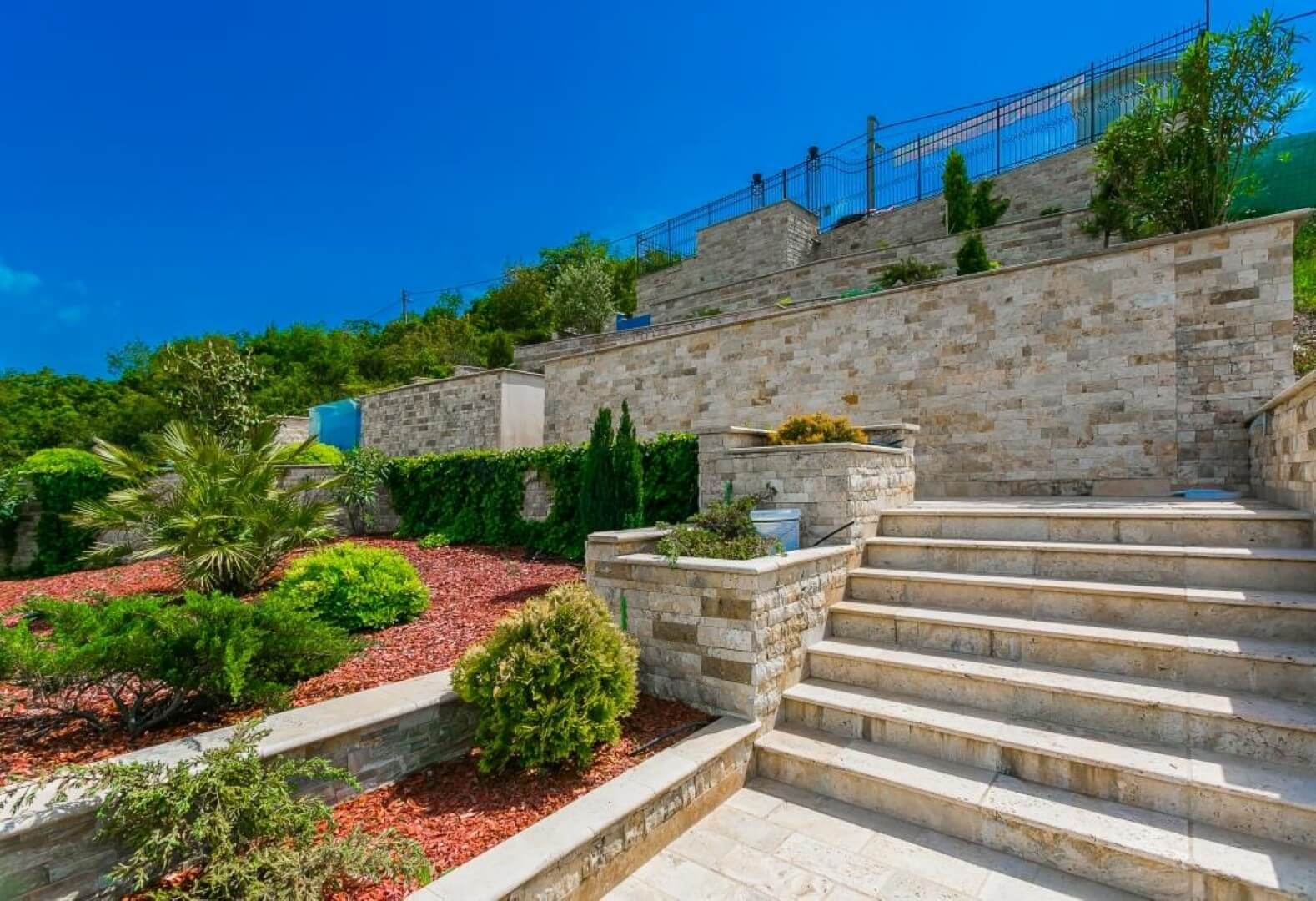 Landscape design and stone staircase of a villa in Krašići, Montenegro: a terraced plot with ornamental plants.