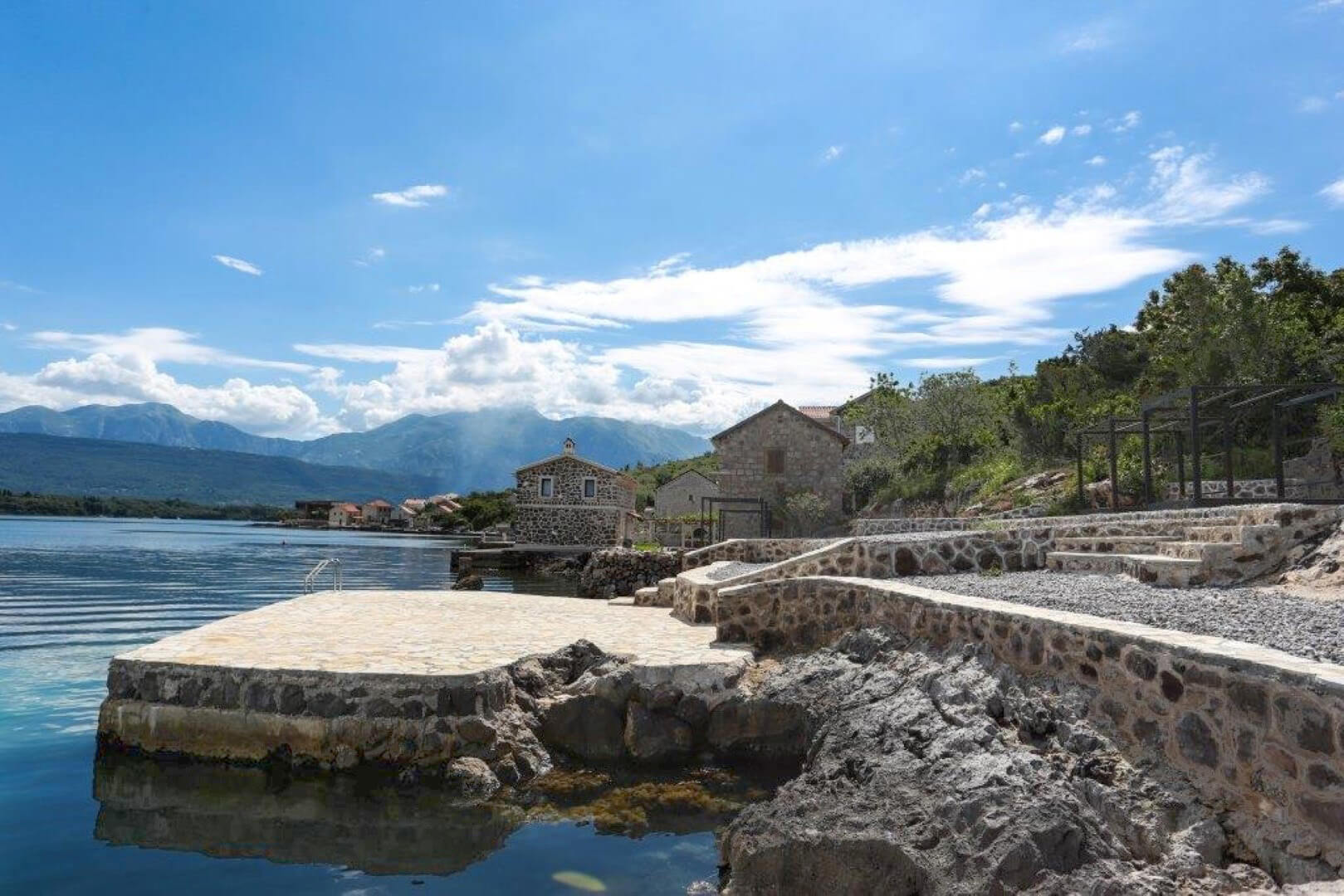 Stone villa with a private pier on the seashore in Krašići, Montenegro, mountain and bay view.