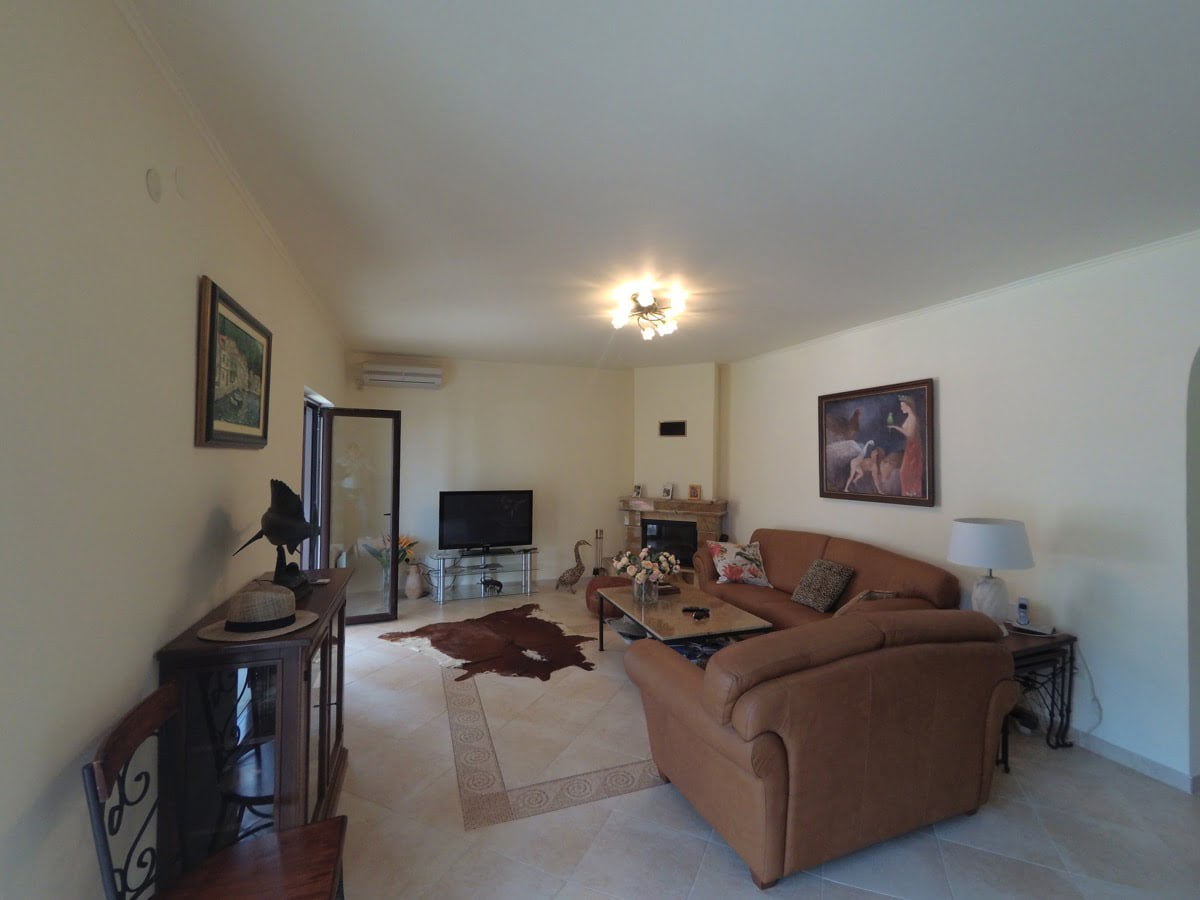 Cozy living room with a leather sofa and fireplace in a villa in Prčanj, Montenegro: interior with classic furniture.