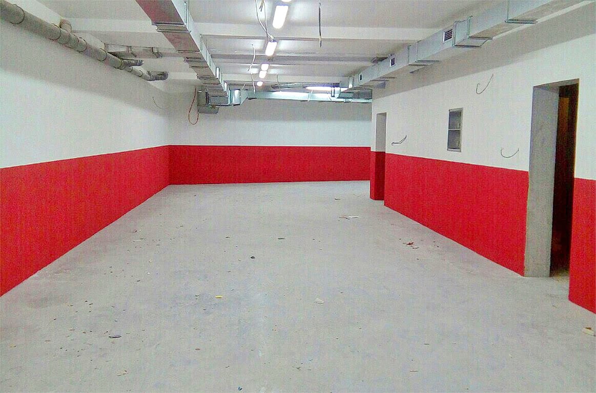 Vacant commercial premises for finishing in Kotor, Montenegro, with exposed utilities and a concrete floor.