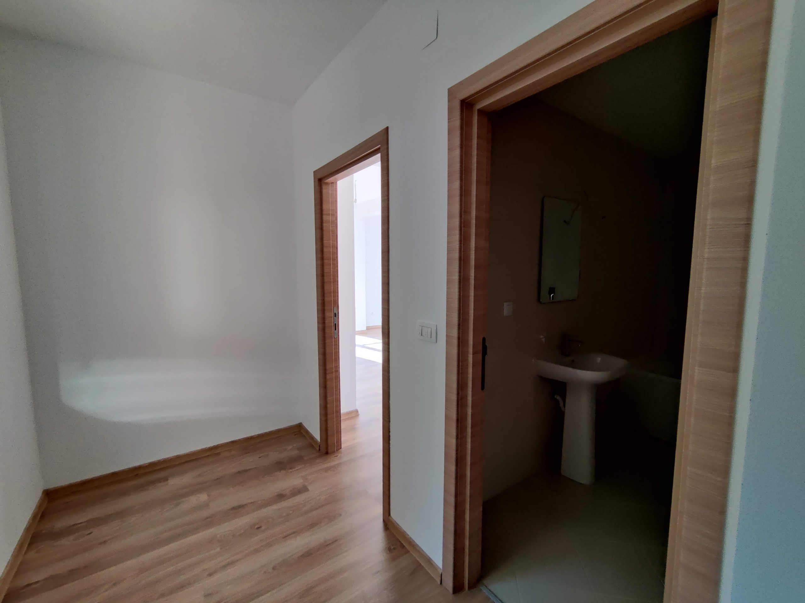Bright hallway with laminate flooring and entrance to the bathroom in an apartment, Bečići, Montenegro.