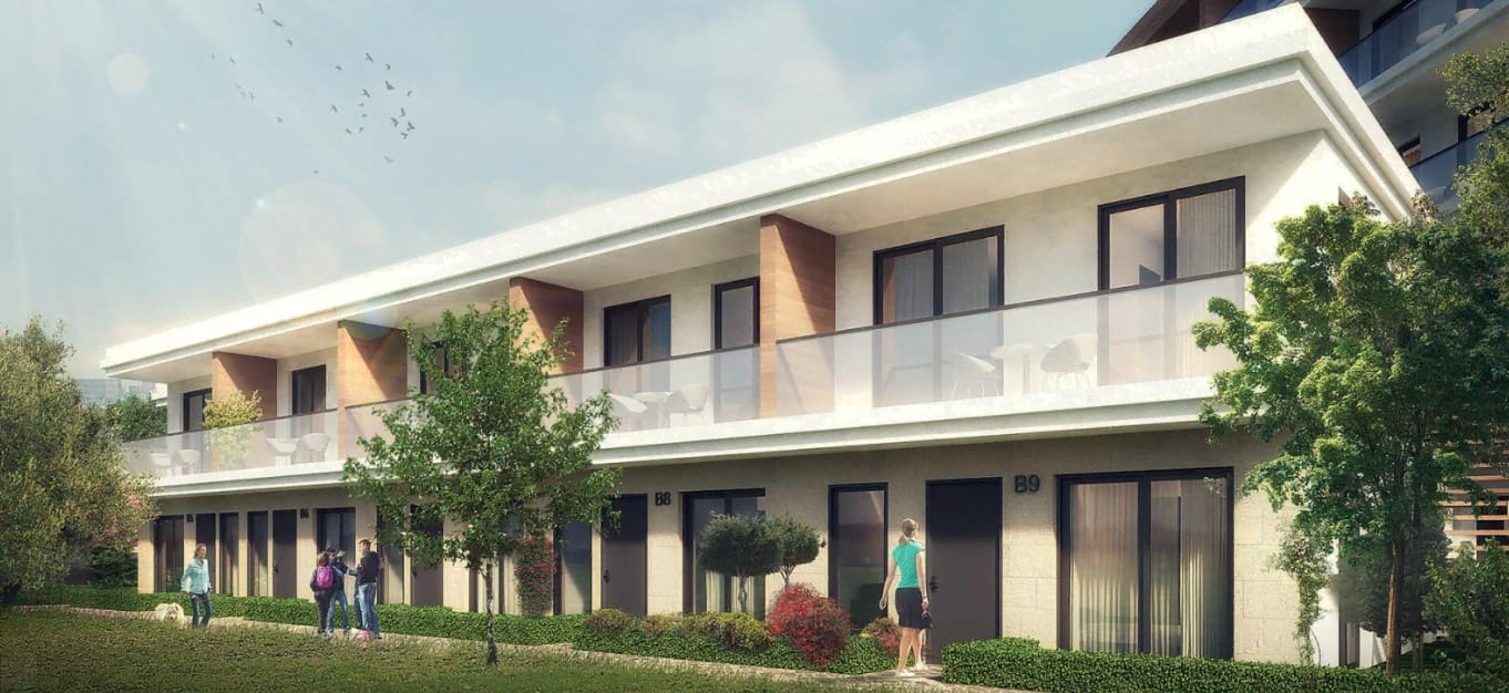 Modern residential complex in Kavac, Montenegro: a two-story building with terraces, panoramic windows, and landscaping.