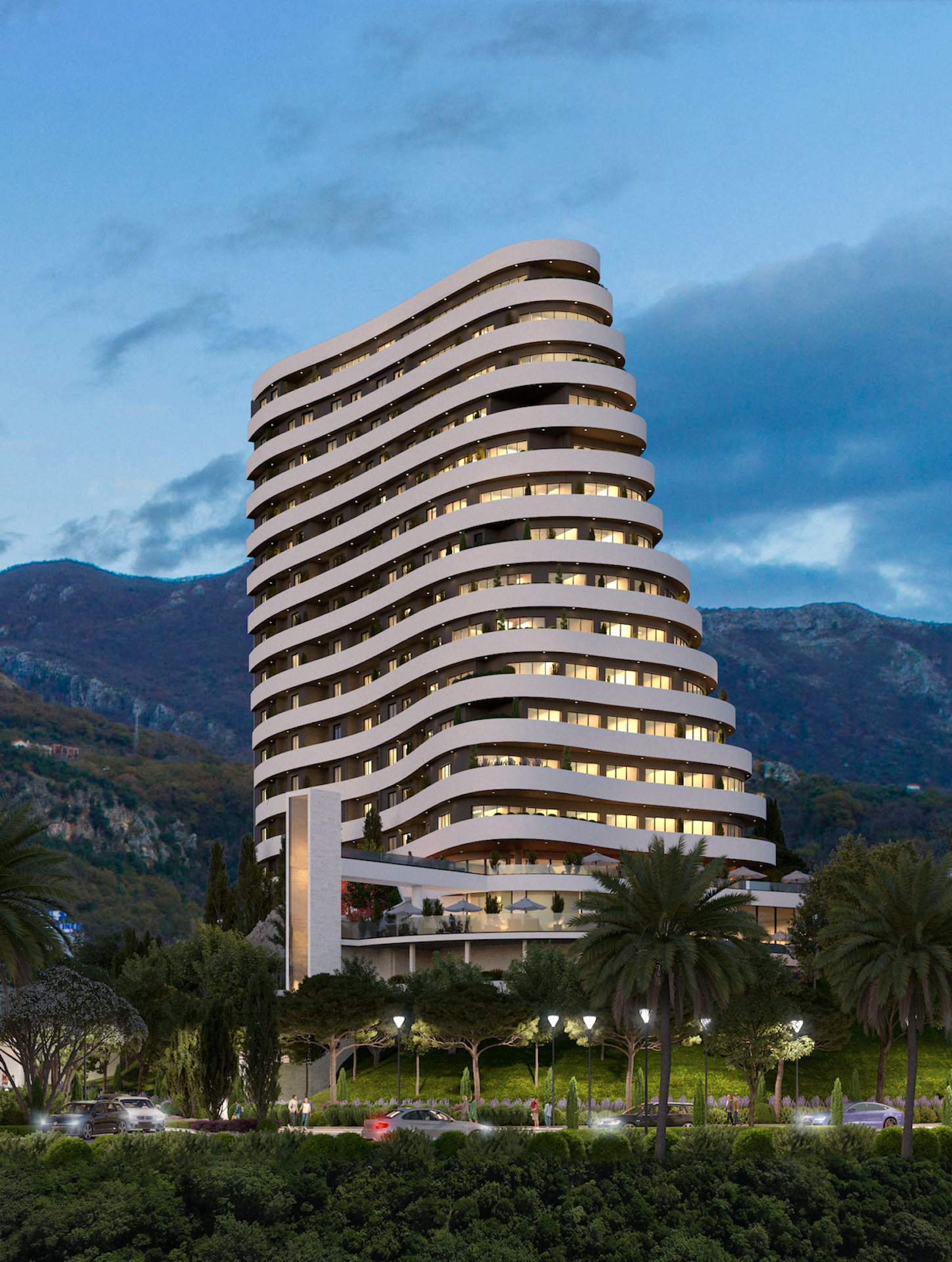 Modern residential complex with panoramic terraces in Bečići, Montenegro: view of the building and mountains in the evening.