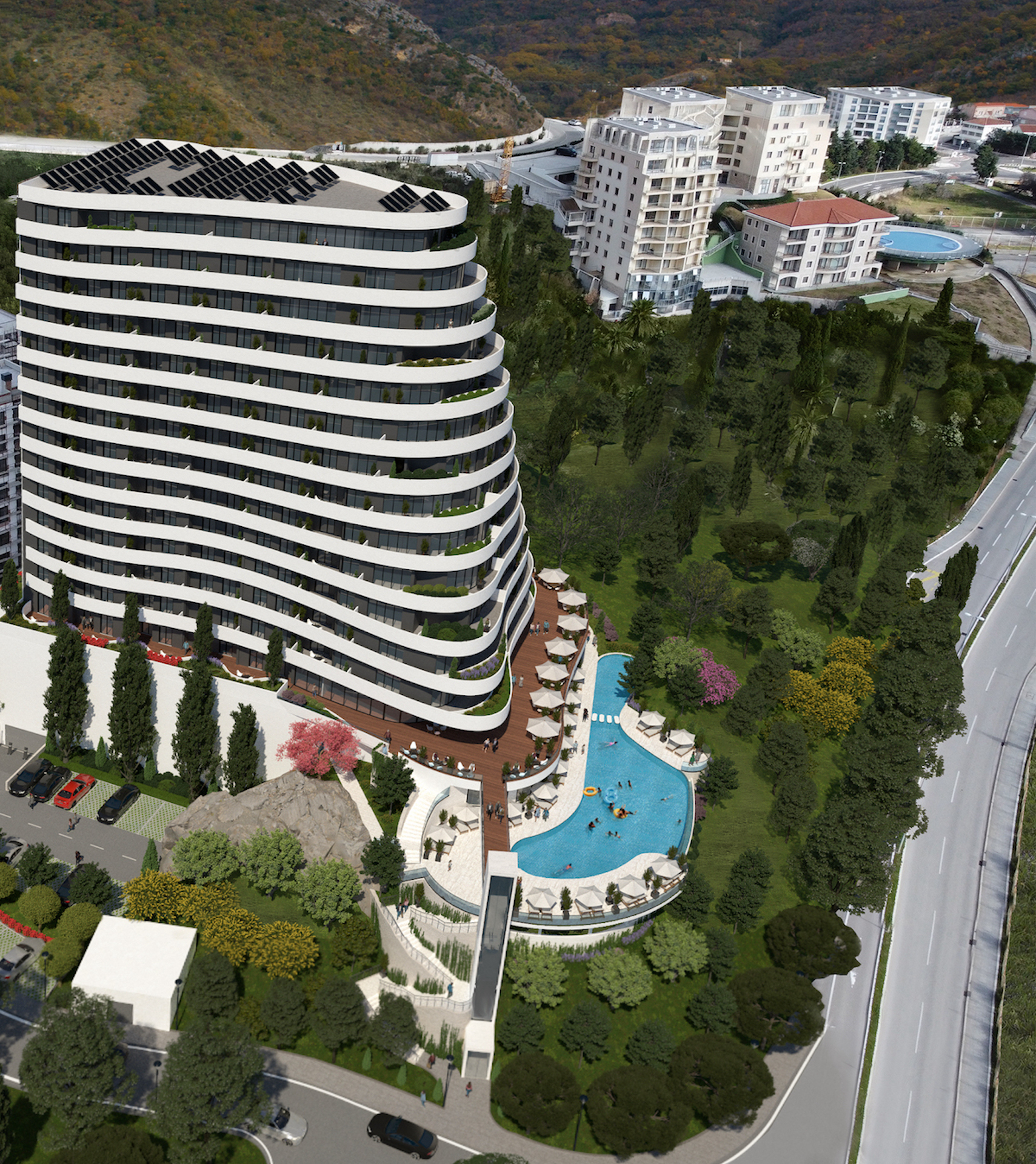 Modern residential complex in Bečići, Montenegro: panoramic view of the building with a swimming pool, terrace, and parking.