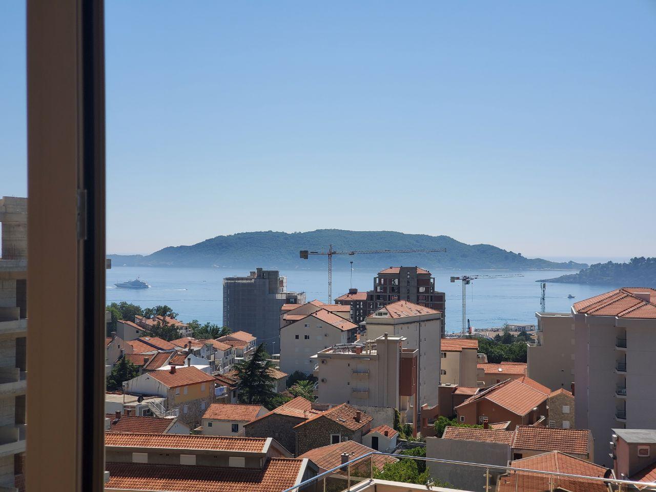View from the balcony of the sea, St. Nicholas Island, and the town of Bečići, Montenegro. Panorama of residential building No. 1247.