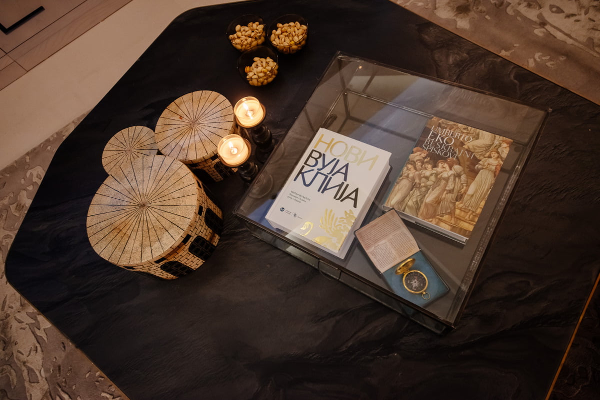 Stylish coffee table with decor in an apartment interior in Kumbor, Montenegro: books, candles, and designer details.