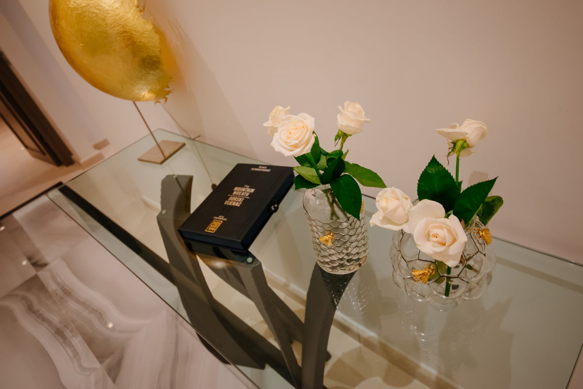 Glass console with flowers and decor in the interior of a luxury apartment in Kumbor, Montenegro.