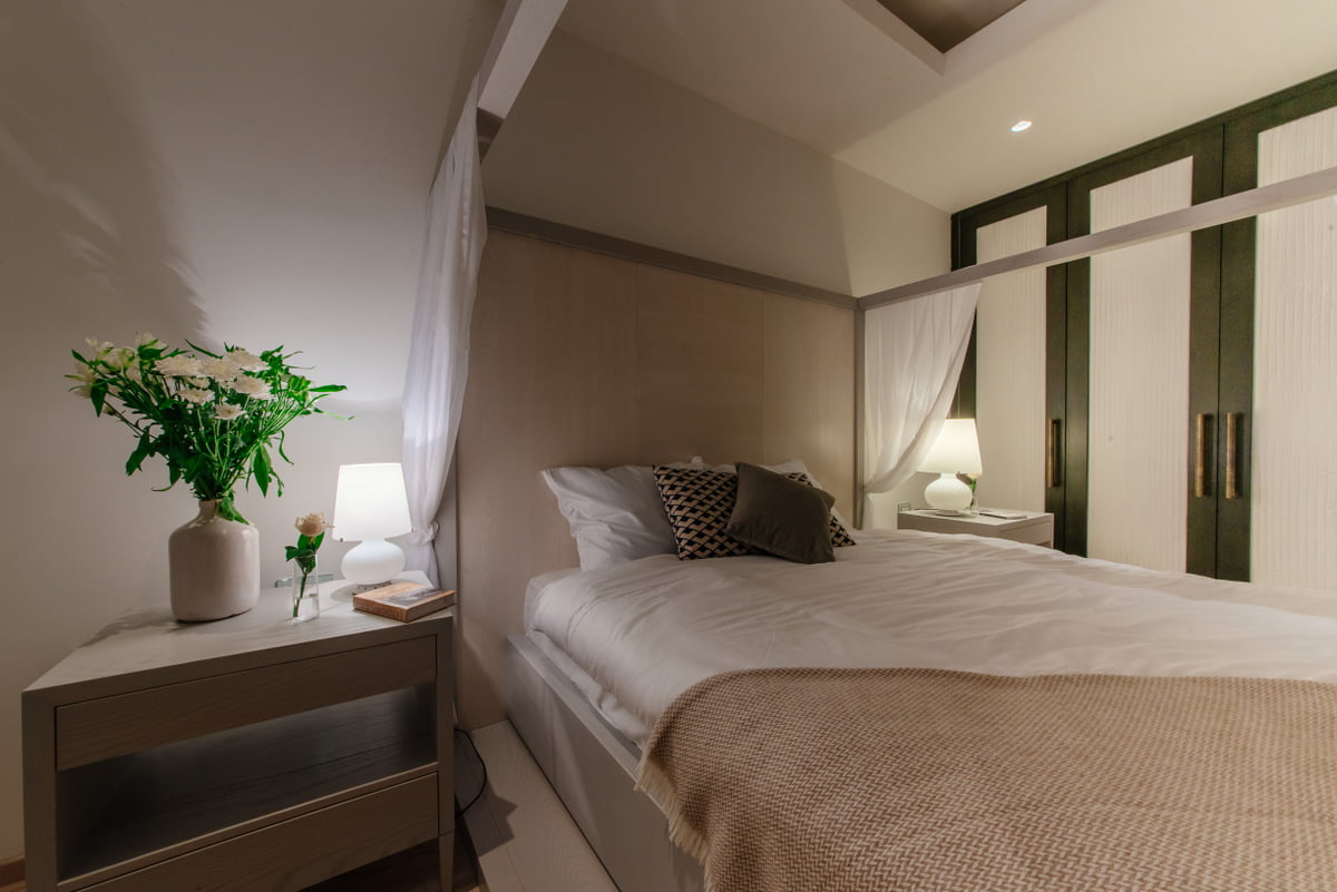 Cozy bedroom in a modern style in an apartment, Kumbor, Montenegro: double bed, light finishes and decor.