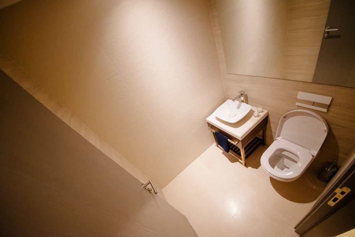 Modern bathroom with white sanitary ware in an apartment in Kumbor, Montenegro: stylish finishes and a mirror.