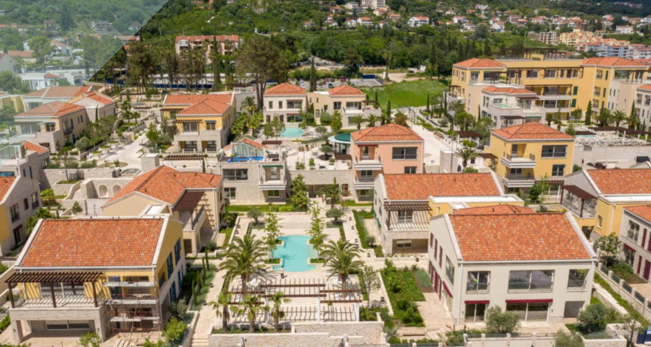 Aerial view of the luxury Porto Novi residential complex in Kumbor, Montenegro: villas with swimming pools and landscaped grounds.