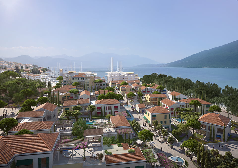 View of the luxury Porto Novi residential complex in Kumbor, Montenegro: villas with tiled roofs, a marina, and a sea bay.