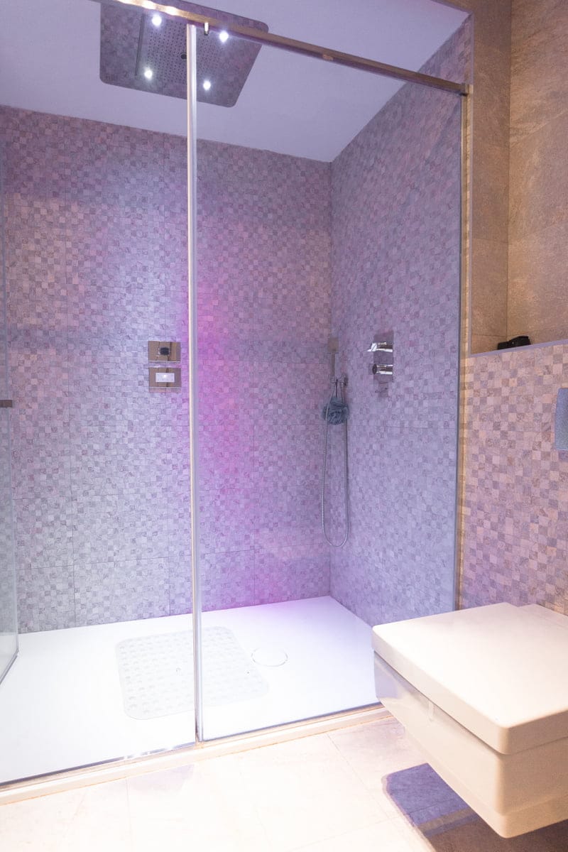 Modern shower cabin with a tropical shower and lighting in the bathroom of an apartment in Ljuta, Montenegro.