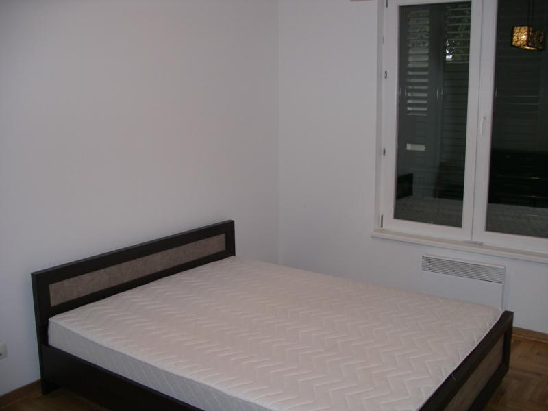 Bedroom with a double bed and panoramic window in an apartment, Herceg Novi, Montenegro. Bright finishes and parquet flooring.