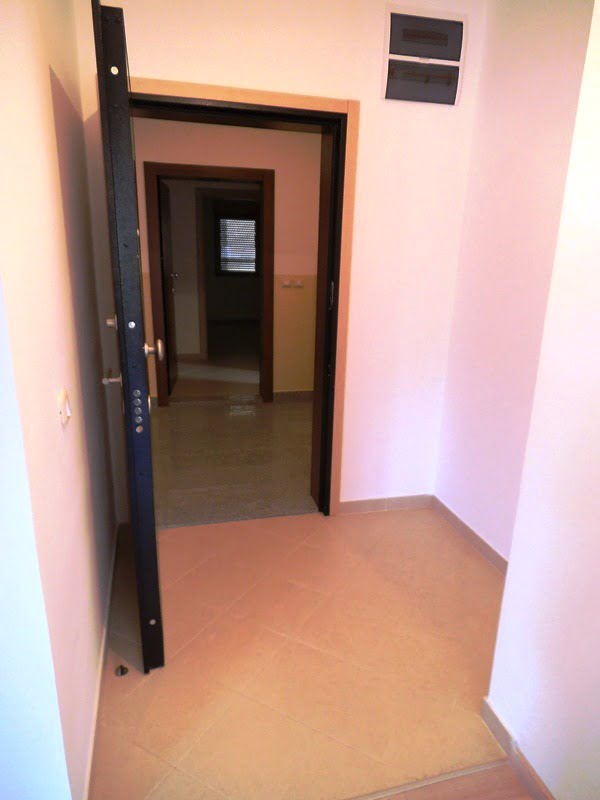Entrance to the apartment with a metal door and light finishes in a residential complex, Bečići, Montenegro.