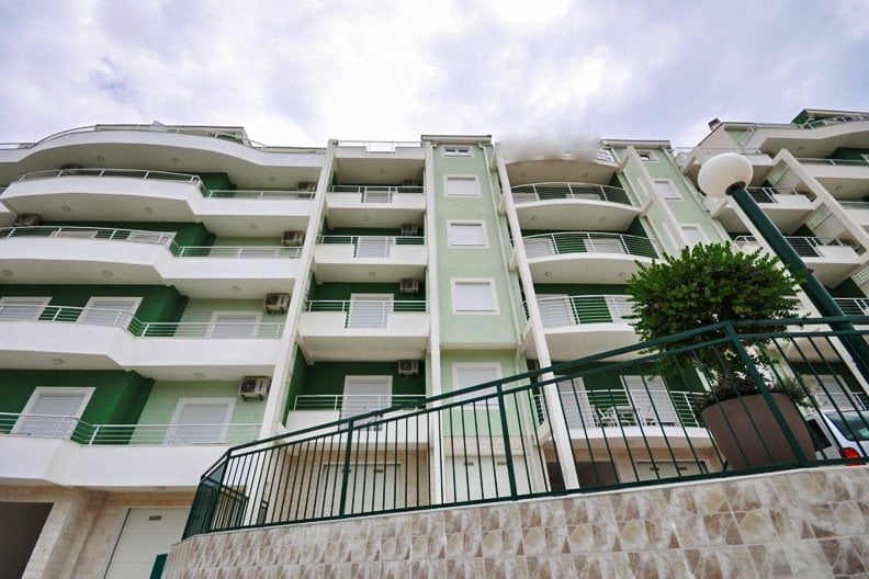 Facade of a modern apartment building with balconies in the city of Herceg Novi, Montenegro. Exterior view of the residential complex.