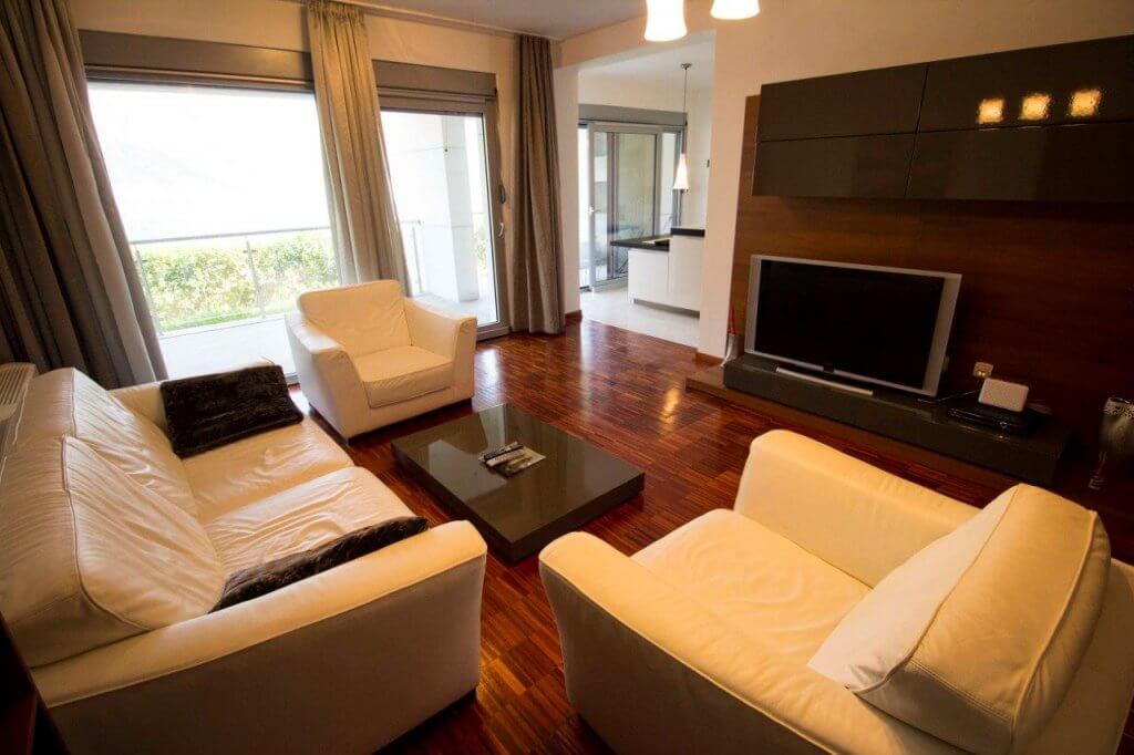 Modern living room with white leather furniture and panoramic windows in an apartment, Stoliv, Bay of Kotor, Montenegro