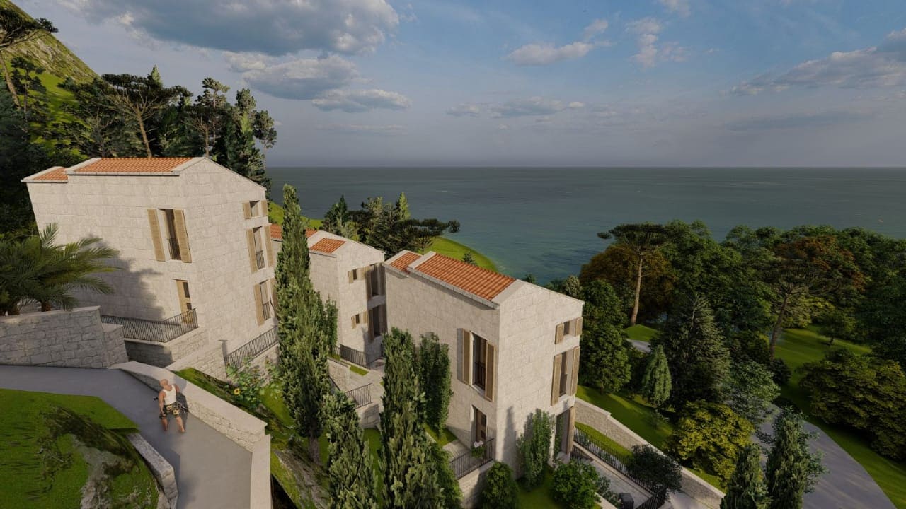 View of stone villas with a development project by the sea in Kamenovo, Montenegro, with panoramic views of the Adriatic coast.