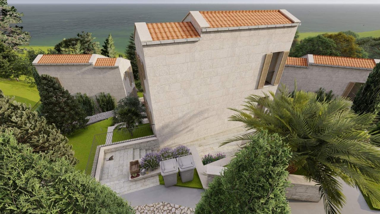 Top view of a modern stone villa with a tiled roof and landscaped grounds in Kamenovo, Montenegro.