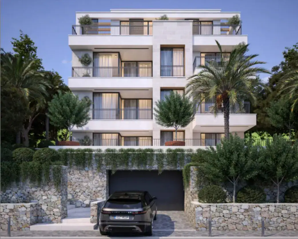Modern residential complex in Tivat, Montenegro: building facade with terraces, stone cladding, and underground parking.