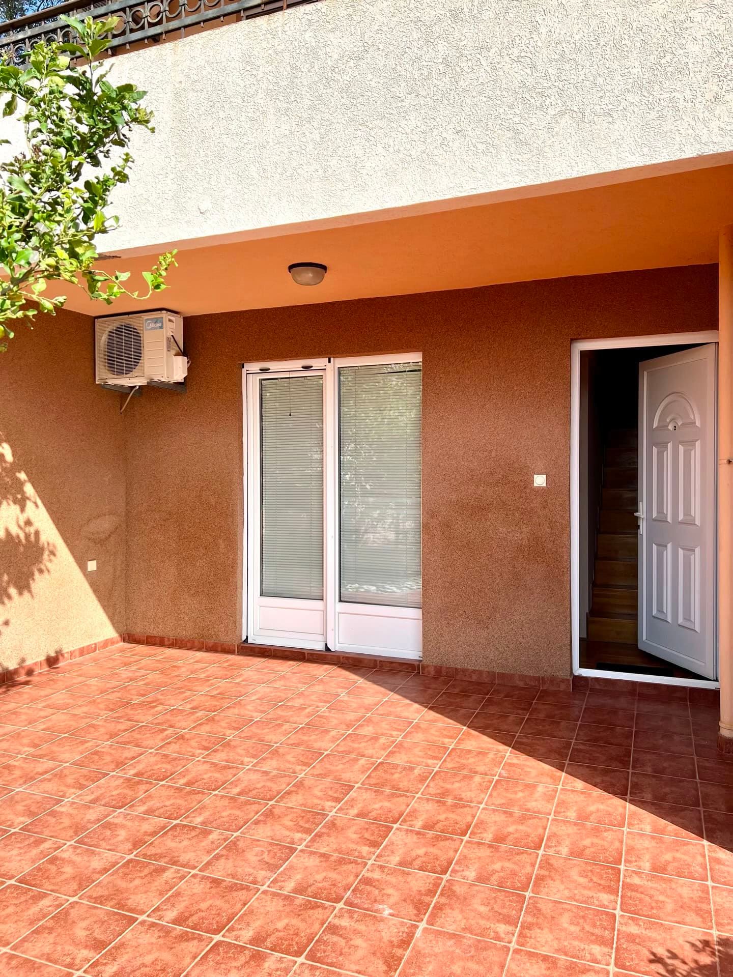 Spacious terrace with tiled flooring and entrance to a duplex in Petrovac, Montenegro.