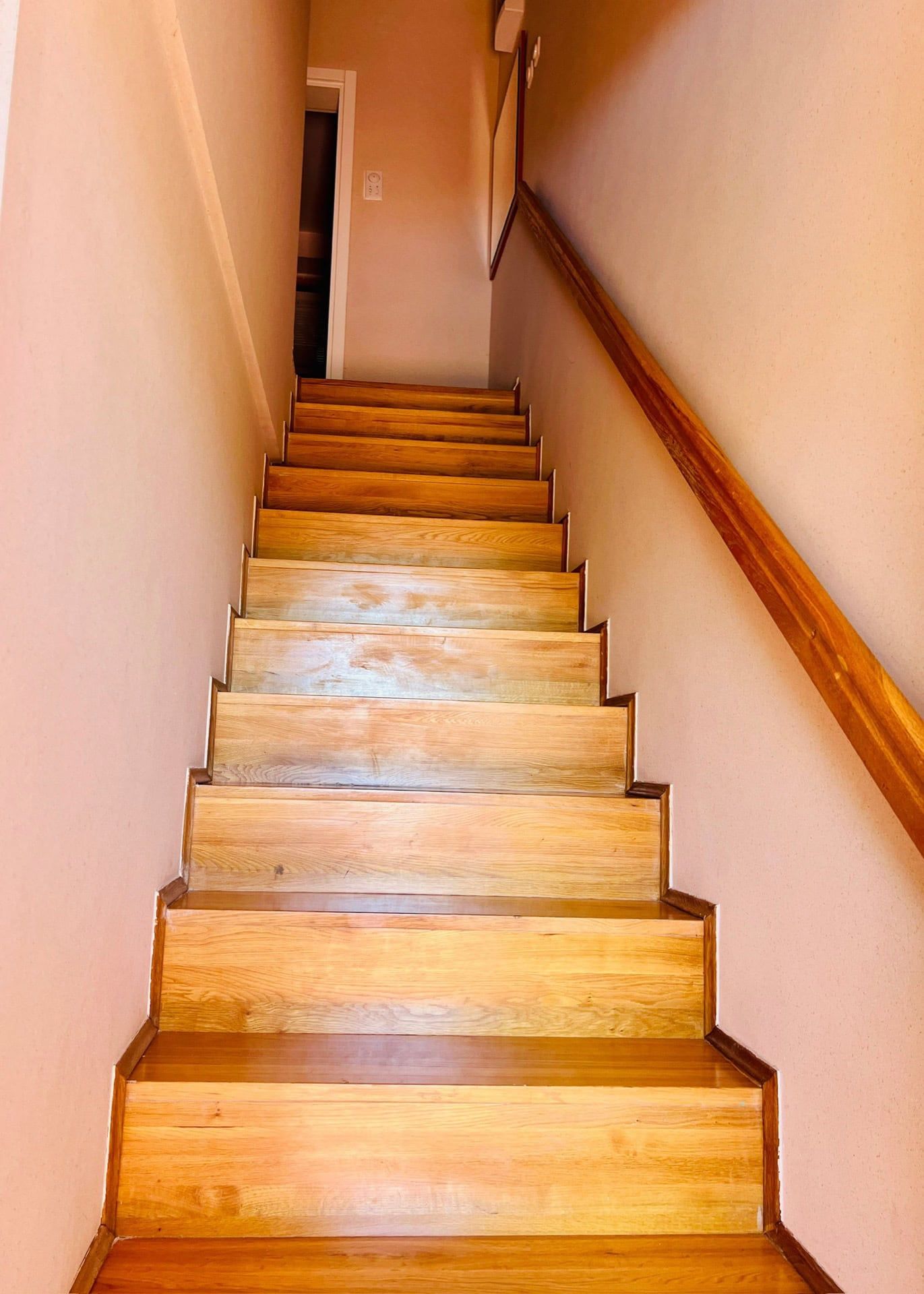 Wooden staircase with railings in the interior of a duplex in Petrovac, Montenegro.