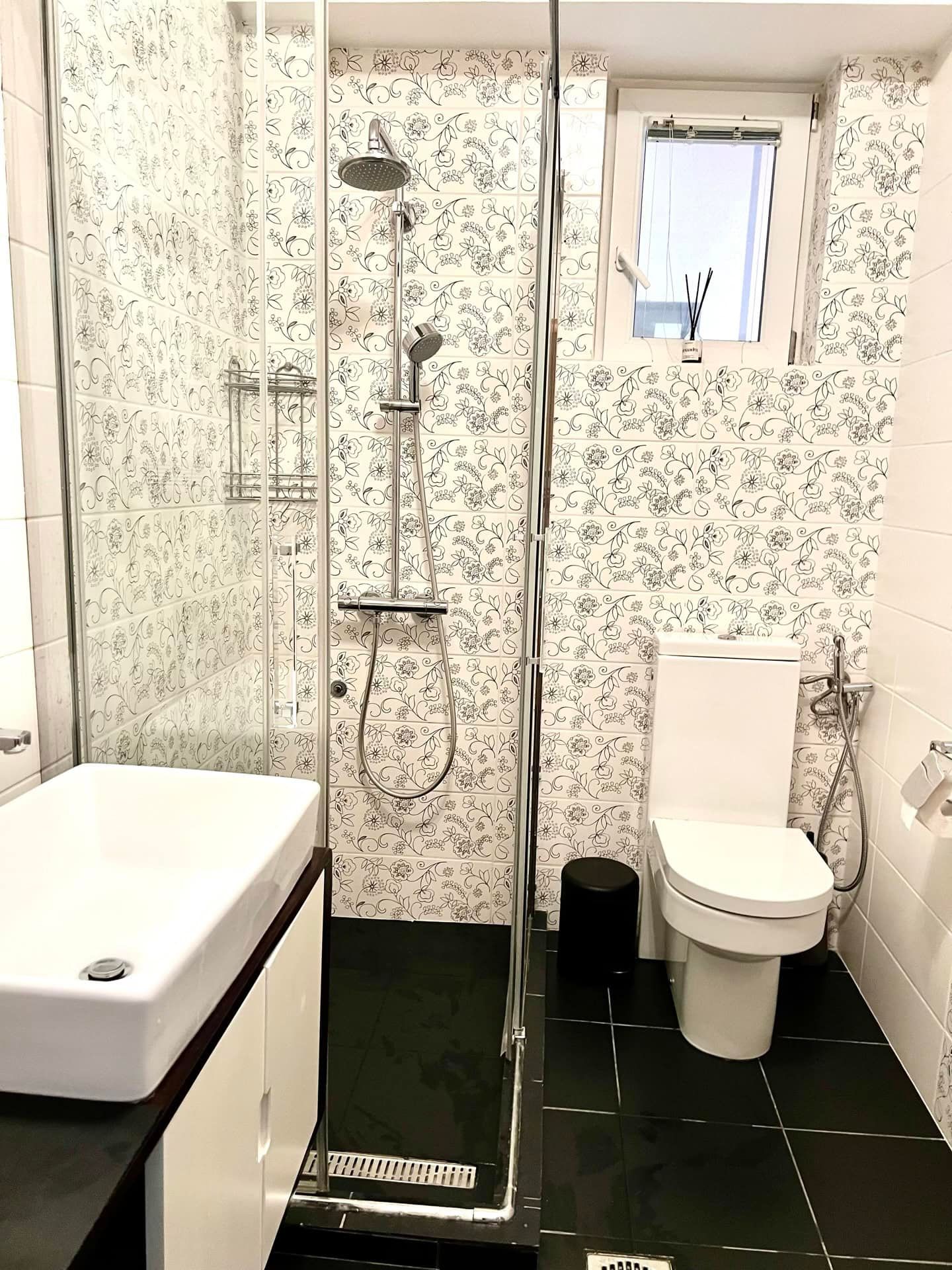 Modern bathroom with a shower cabin in an apartment in Petrovac, Montenegro: stylish tiles and fixtures.
