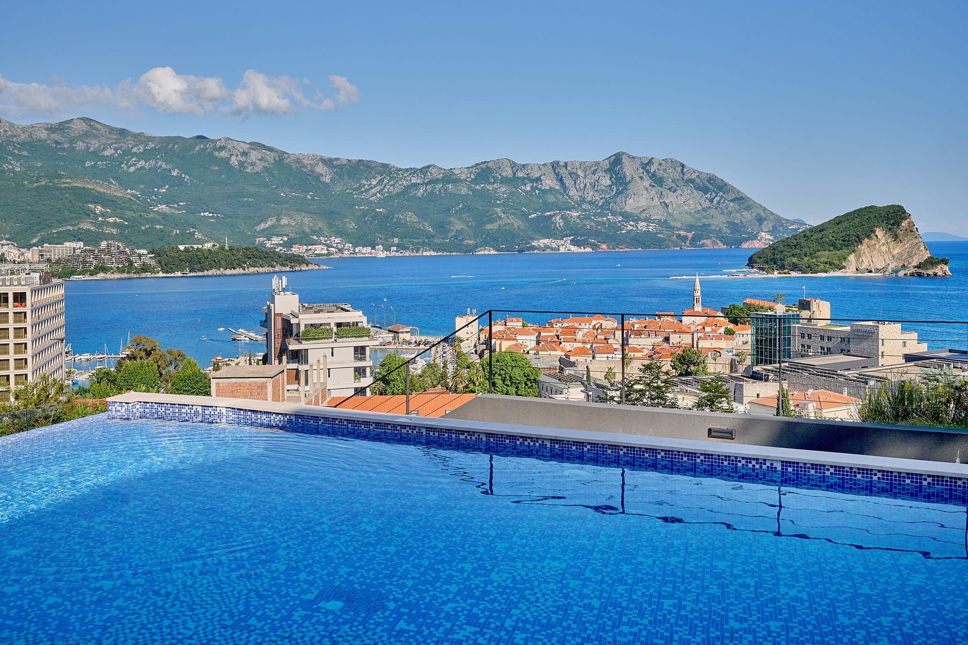 Panoramic pool with views of Budva Old Town, the sea, and the mountains, Montenegro. Apartment in a luxury residential complex.