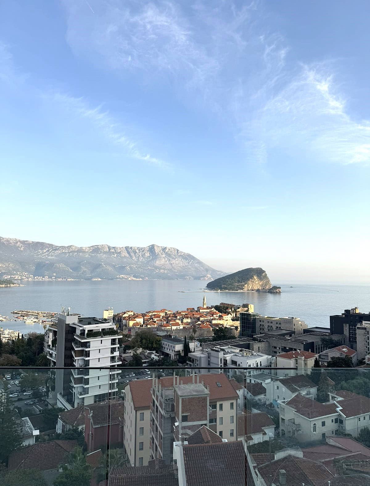 Panoramic view from the balcony of Budva Old Town, St. Nicholas Island, and the mountains, Montenegro.