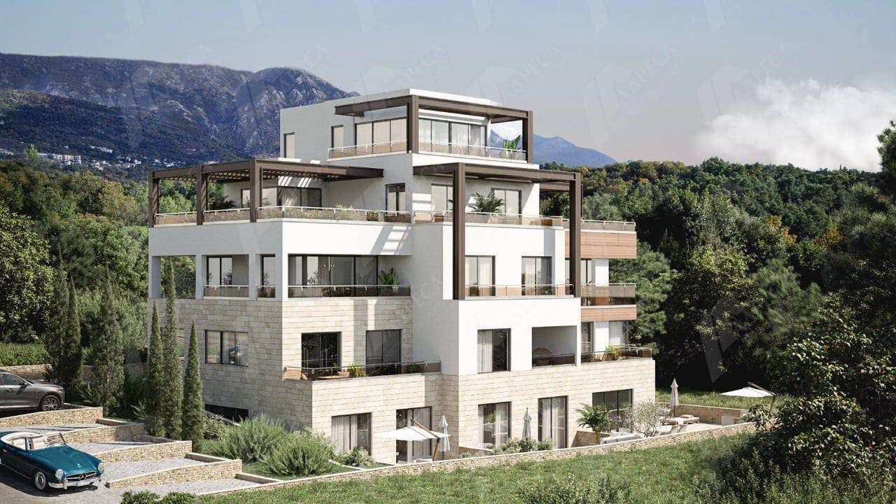 Modern villa with terraces in Tivat, Montenegro: view of an apartment building with panoramic windows and mountains.