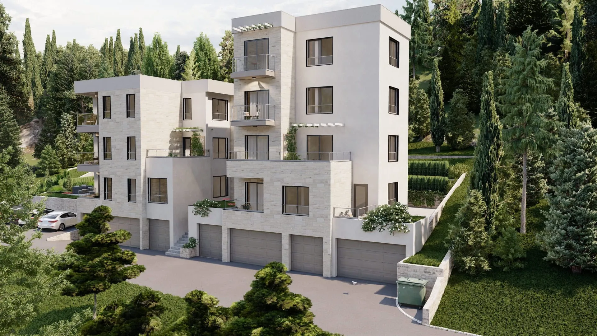 Exterior view of a modern multi-story residential building with balconies and garages surrounded by trees.