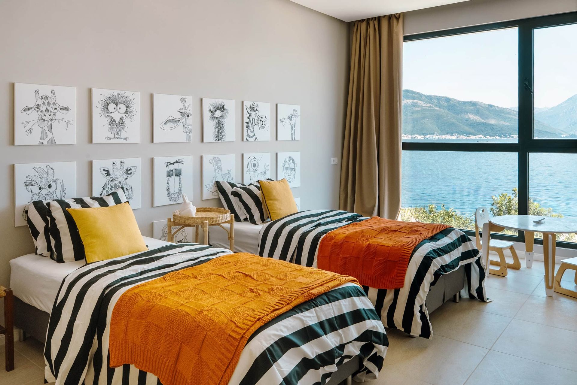 Children's bedroom in a villa in Krašići, Montenegro: two beds, sea and mountain views, modern interior with decor.
