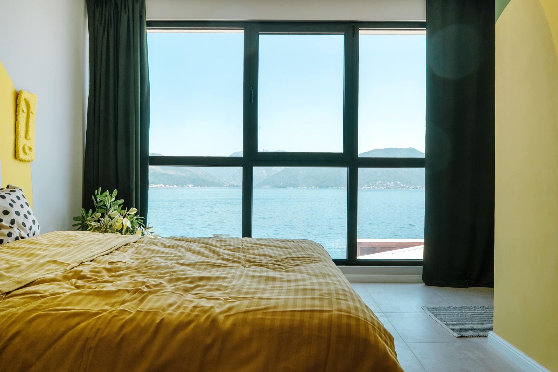 Bedroom with a panoramic view of the sea and mountains in a villa, Krašići, Montenegro: double bed and modern interior.