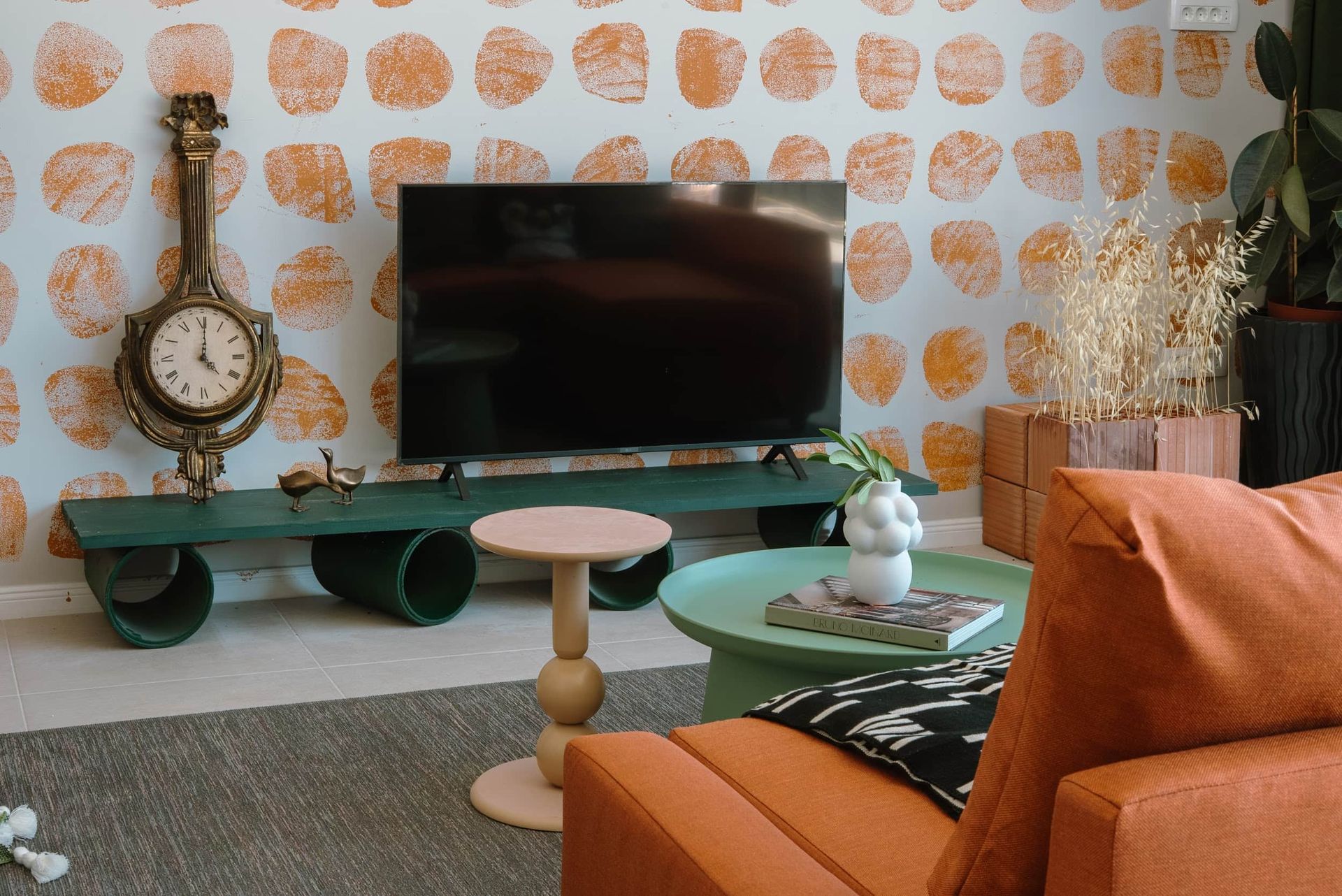 Living room of a villa in Krašići, Montenegro: designer furniture, TV area, vintage clock, and vibrant interior decor.