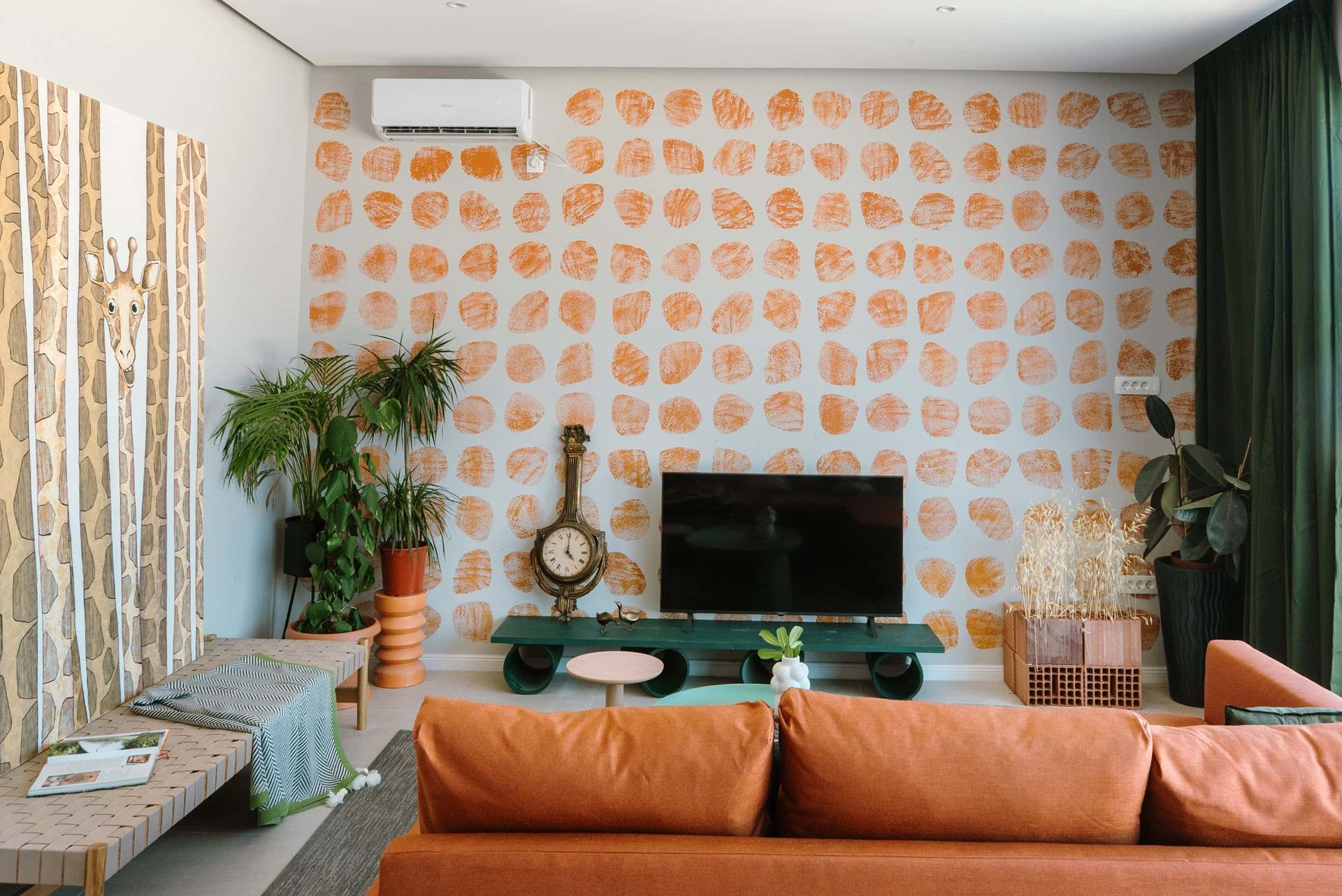 Designer living room interior in a villa in Krašići, Montenegro: orange sofa, accent wall, and decor.