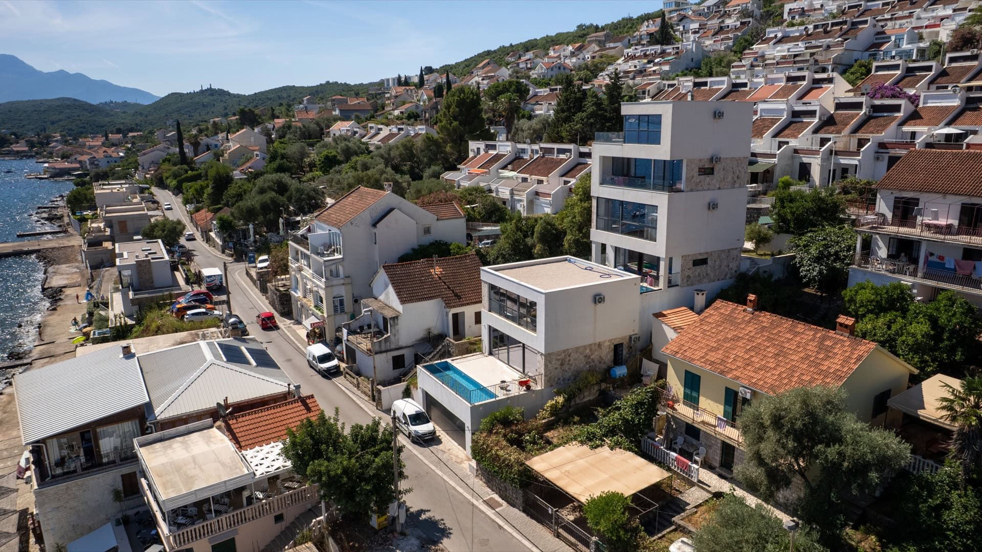 Modern villa with a swimming pool and panoramic sea views in Krašići, Montenegro: aerial view of the property.