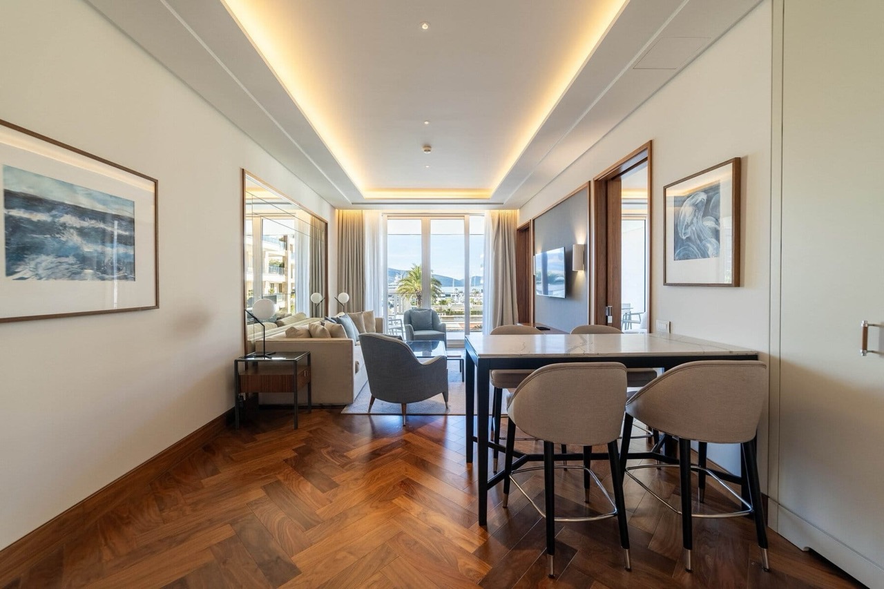 Modern living room in an apartment in Porto Montenegro, Tivat, Montenegro: parquet flooring, stylish furniture, and a view of the marina.