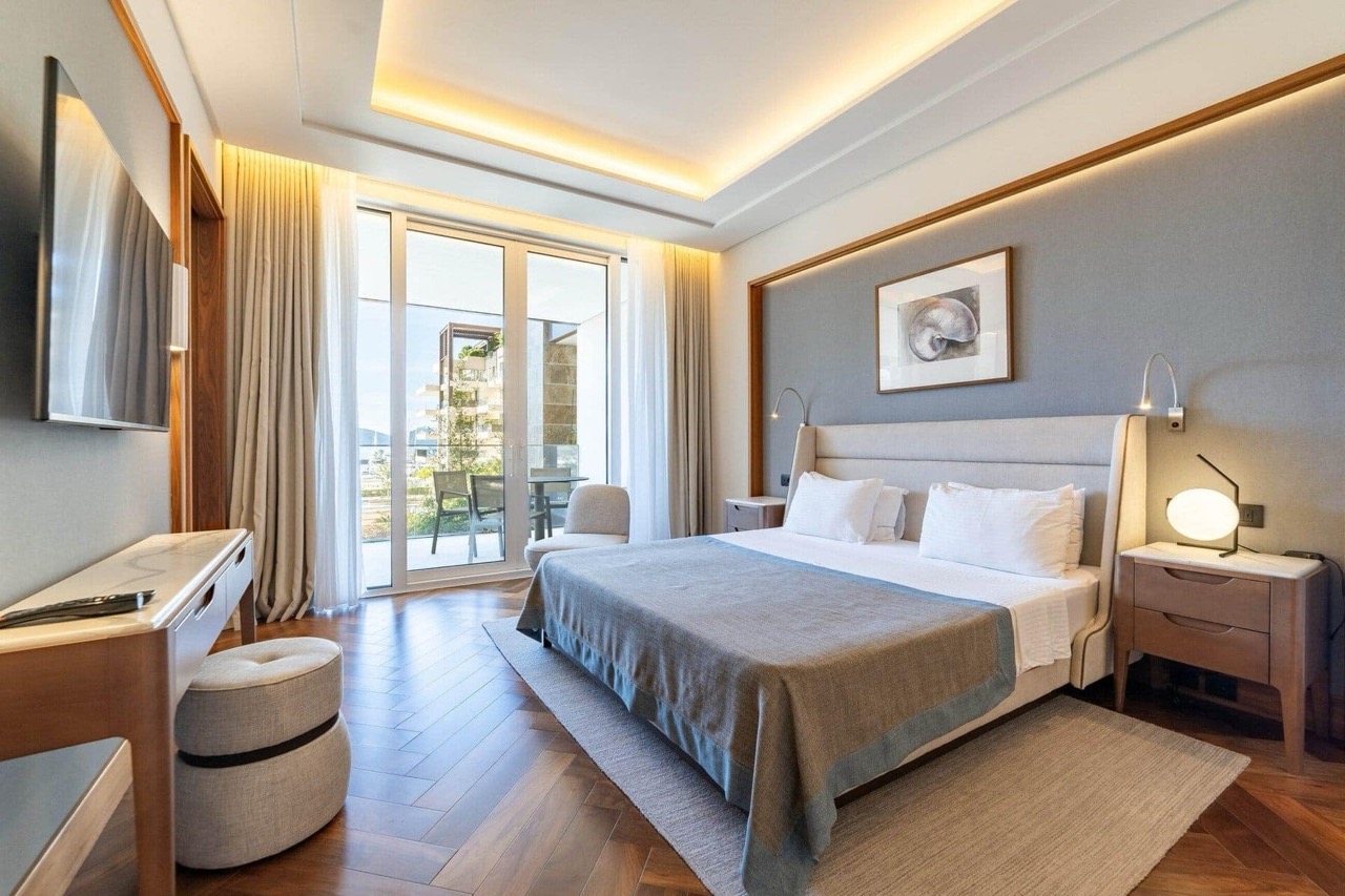 Modern bedroom in an apartment in Porto Montenegro, Tivat, Montenegro: double bed, terrace, and sea view.