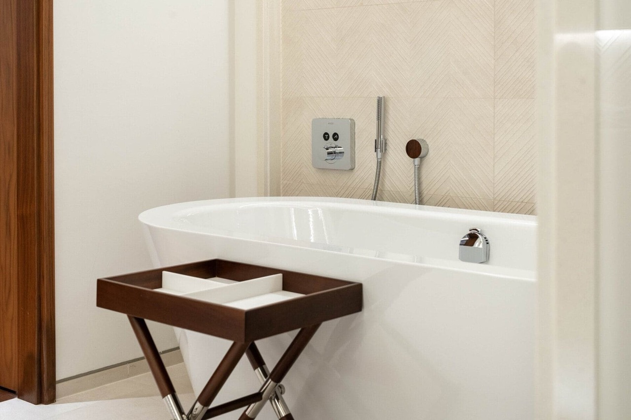 Modern bathroom in an apartment in Porto Montenegro, Tivat, Montenegro: a white bathtub and stylish tile finishes.