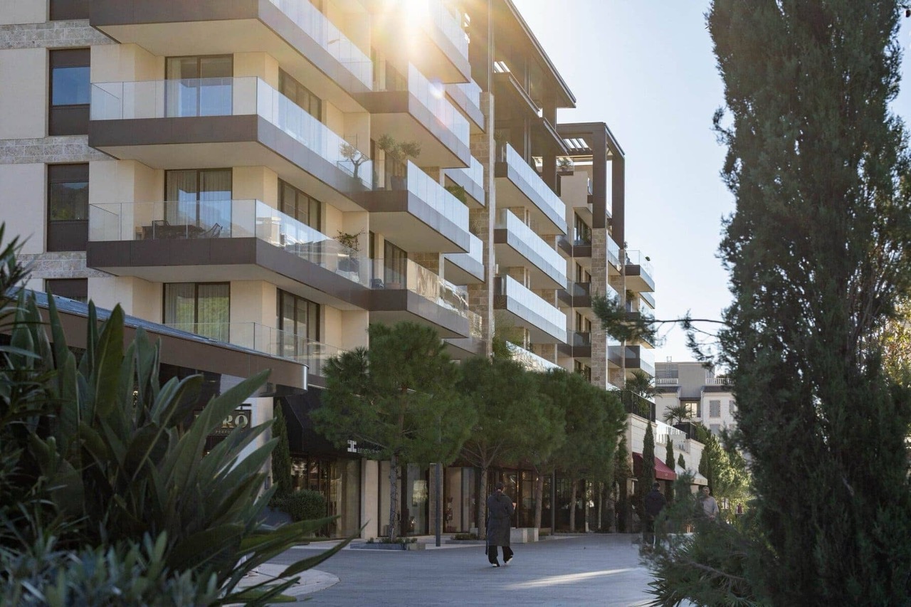 Modern residential complex in Porto Montenegro, Tivat, Montenegro: view of the building facade with terraces and the pedestrian area.