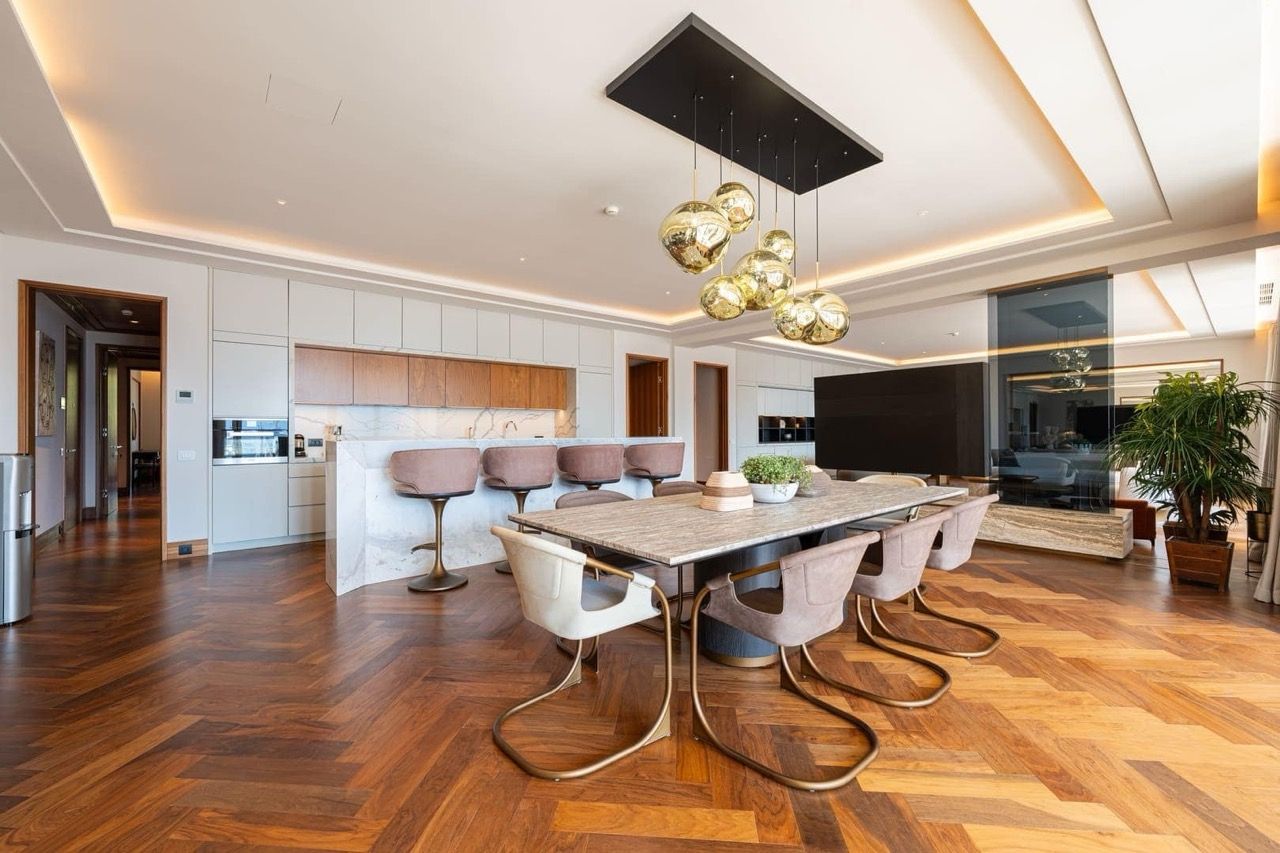 Modern kitchen-dining room in an apartment in Porto Montenegro, Tivat, Montenegro: marble island and designer furniture.