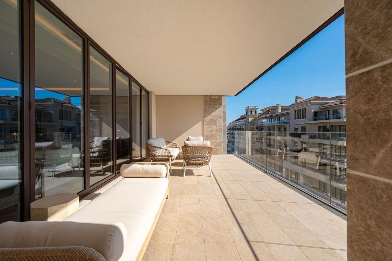 Spacious terrace with wicker furniture in a luxury apartment in Porto Montenegro, Tivat, Montenegro.