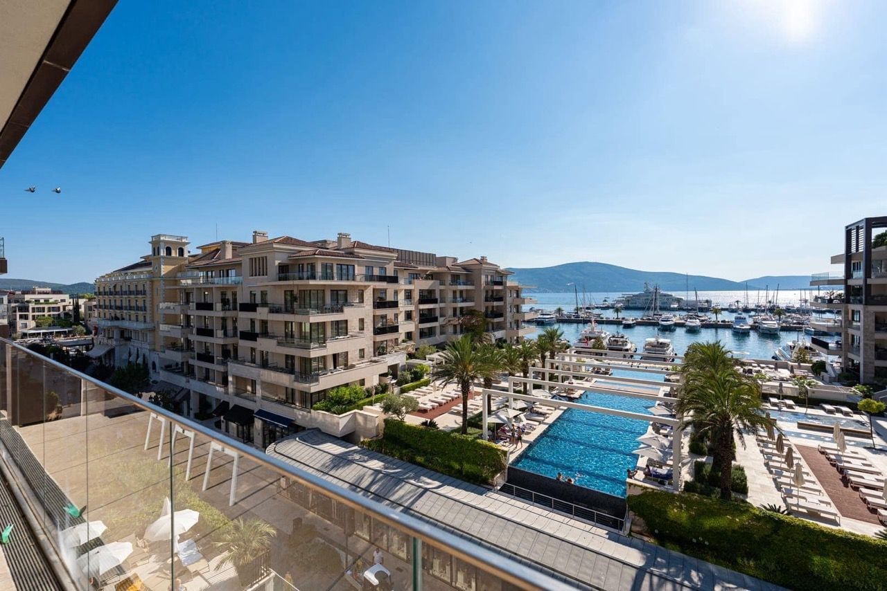 View from the balcony of the pool and Porto Montenegro yacht marina in Tivat, Montenegro: luxury seaside property.
