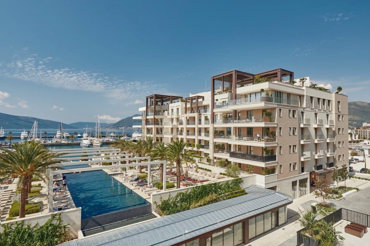 Modern residential complex in Porto Montenegro, Tivat, Montenegro: view of the pool, terraces, and yacht marina.