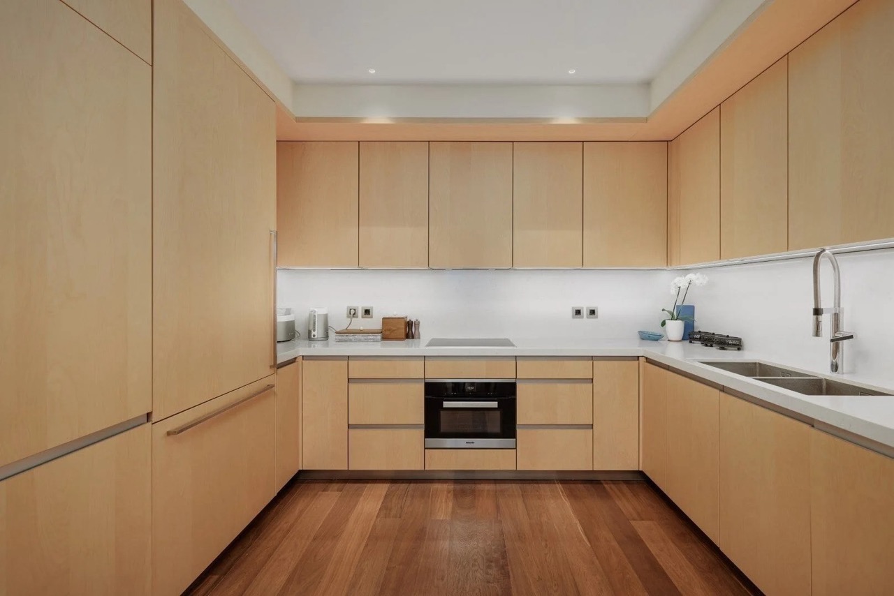 Modern kitchen with wooden fronts in an apartment in Porto Montenegro, Tivat, Montenegro: built-in appliances and design.