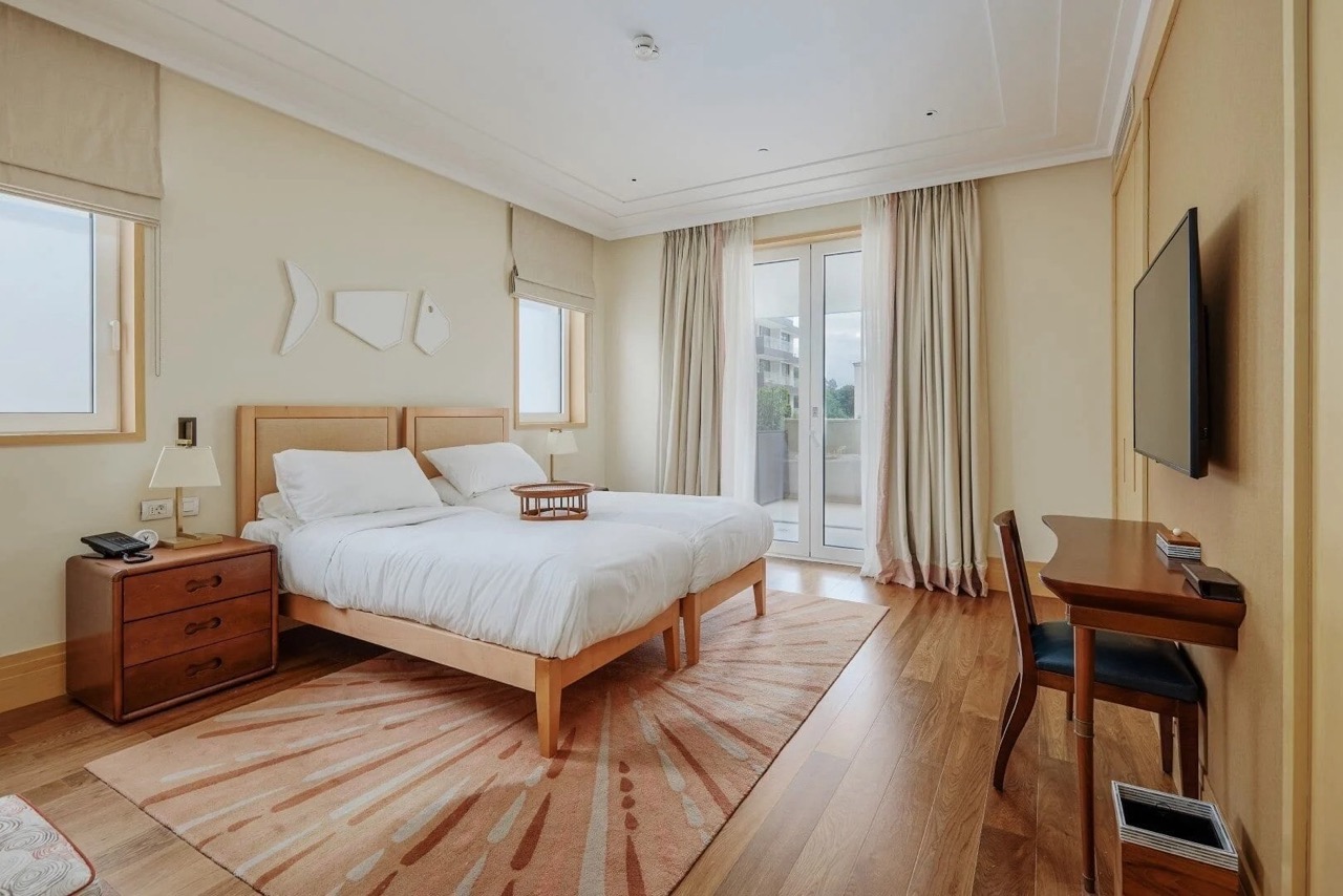 Bright bedroom with two beds and access to the balcony in Porto Montenegro apartments, Tivat, Montenegro.