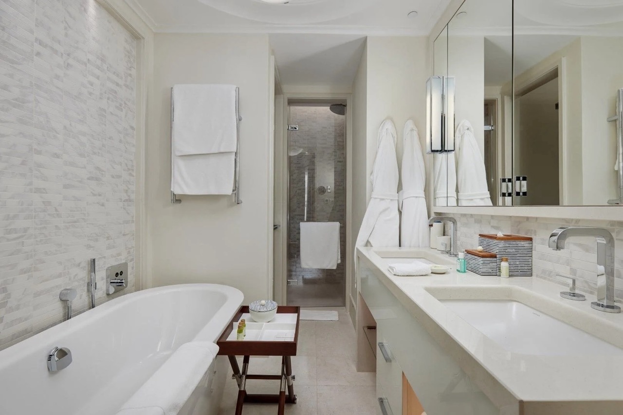 Modern bathroom with a bathtub and two sinks in a luxury apartment in Porto Montenegro, Tivat, Montenegro.