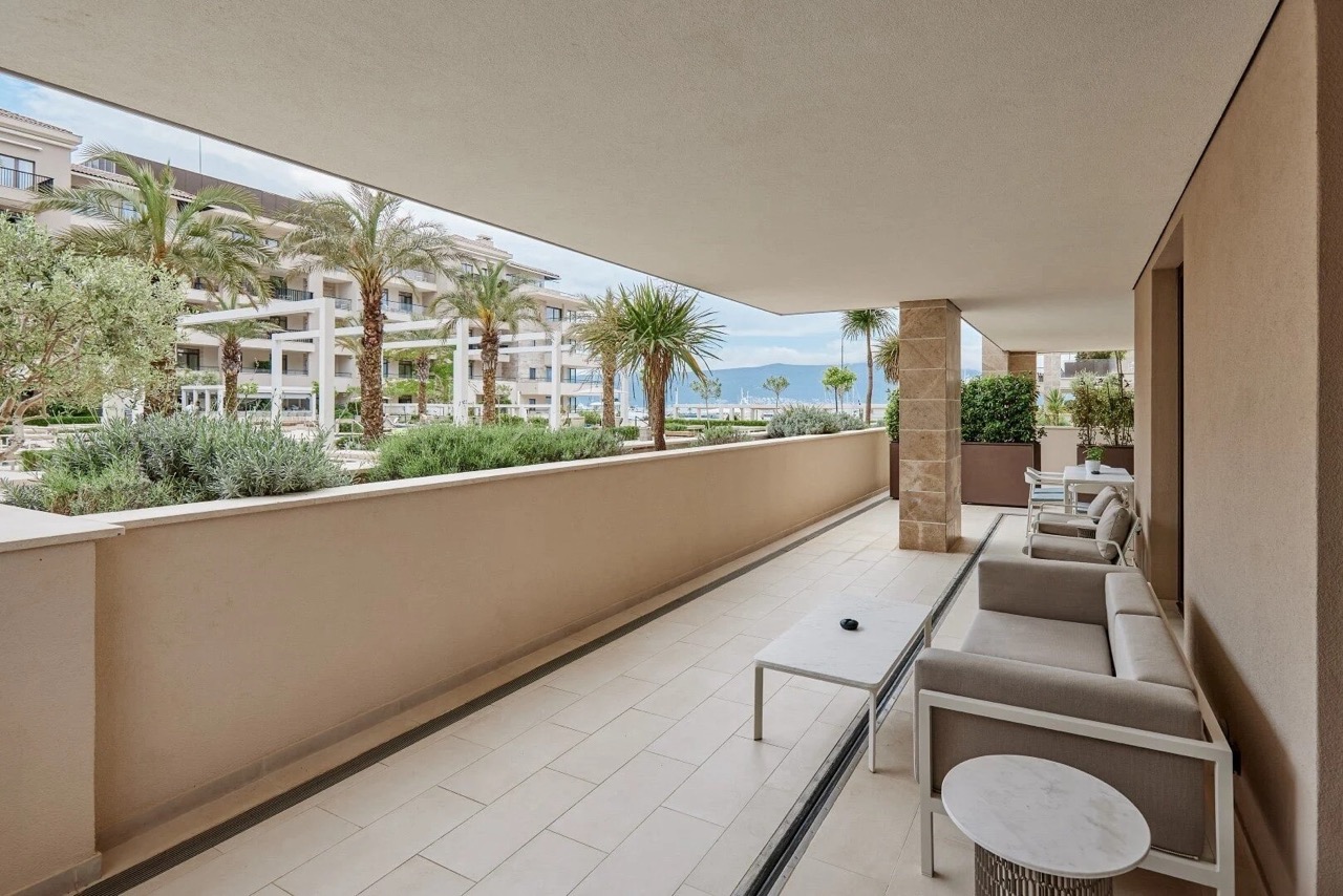 Spacious terrace with furniture in the luxury Porto Montenegro residential complex, Tivat, Montenegro, overlooking the landscape.
